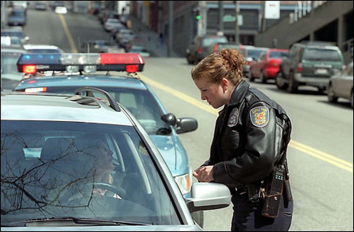 Seattle police Officer P. MacDonald makes a traffic stop at First Avenue and Yesler Way. The routine action is getting less so for law officers.