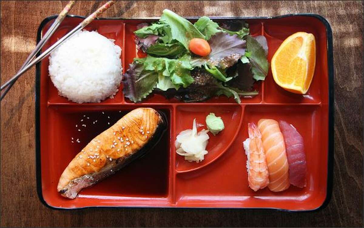 J-Sushi in the International District offers a deal for lunch: a bento box with salmon (or chicken) teriyaki and three pieces of nigiri sushi for $7.95.
