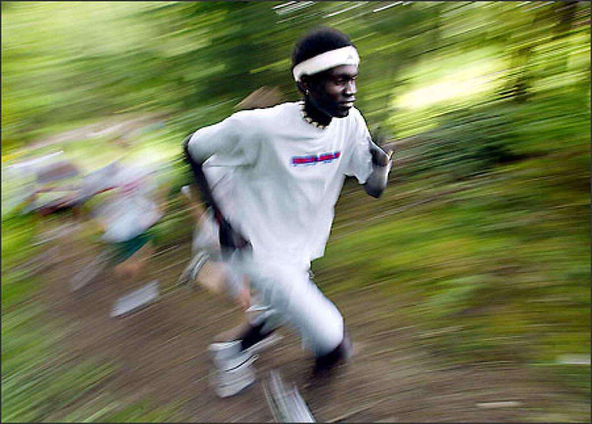 David Mathiang climbs a hill during a recent track team practice at Mountlake Terrace High, but he has been ruled ineligible for competition.