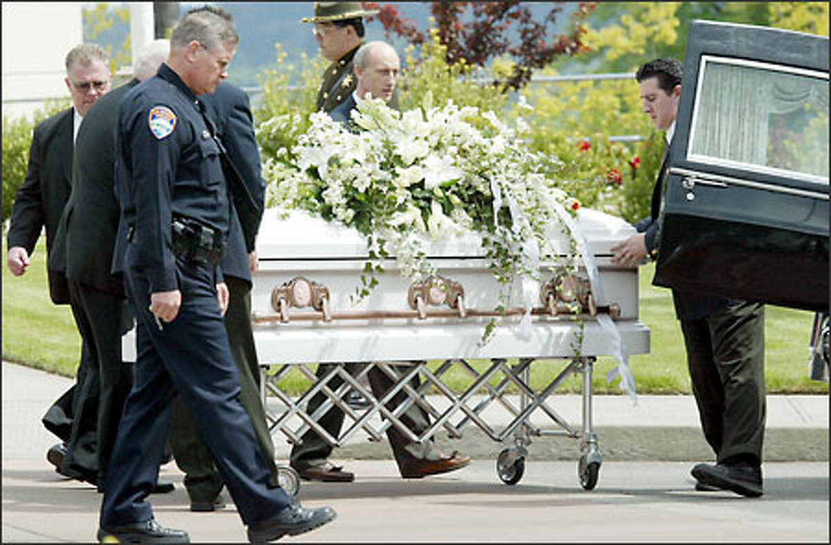 The casket of Crystal Brame is loaded into a hearse following her funeral at Chapel Hill Presbyterian Church in Gig Harbor. Crystal Brame died May 3, a week after she was shot by her husband, Tacoma Police Chief David Brame, who commited suicide.