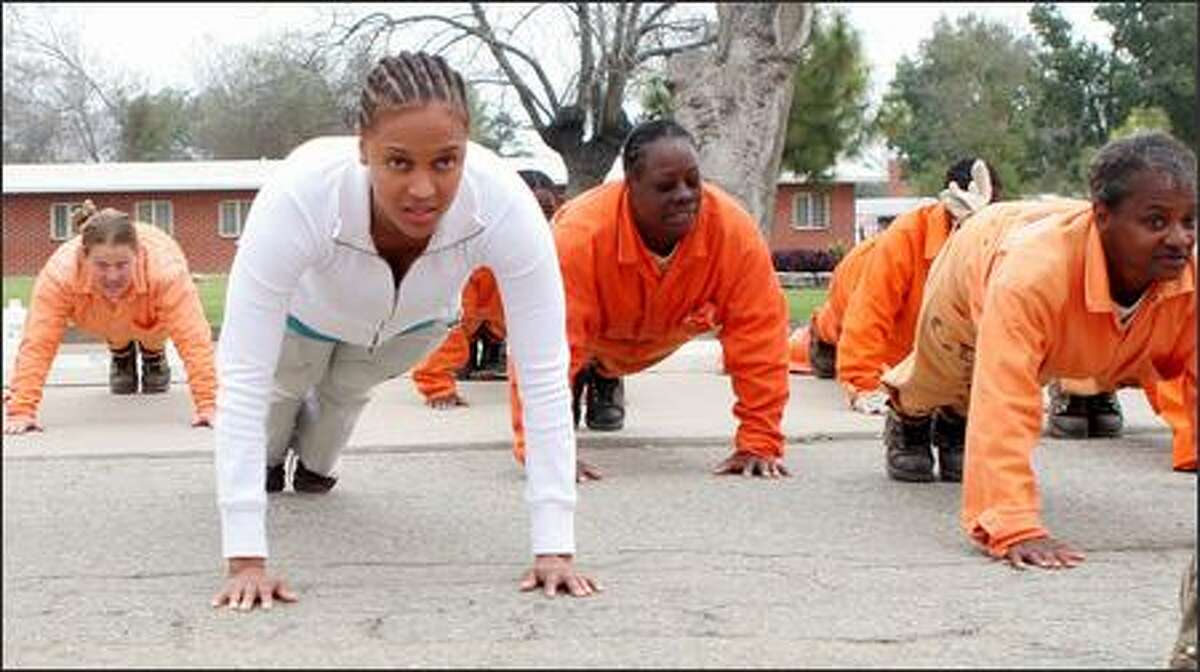This is not a shot that would make it onto "America's Next Top Model" but if Tyra Banks were to go "prison girl," it would be. The model/talk-show host, left, does push-ups next to some of the ladies of the California Institution for Women in Chino, for an episode of "The Tyra Banks Show."