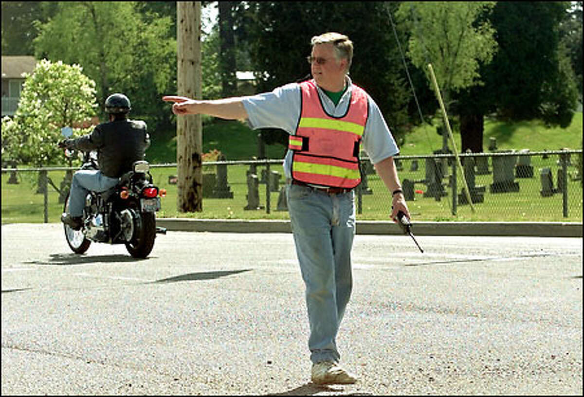 Mayor Bob Kraski directs traffic after authorities closed roads into Arlington during an ammonia leak. He was on 67th Avenue Northeast south of town.