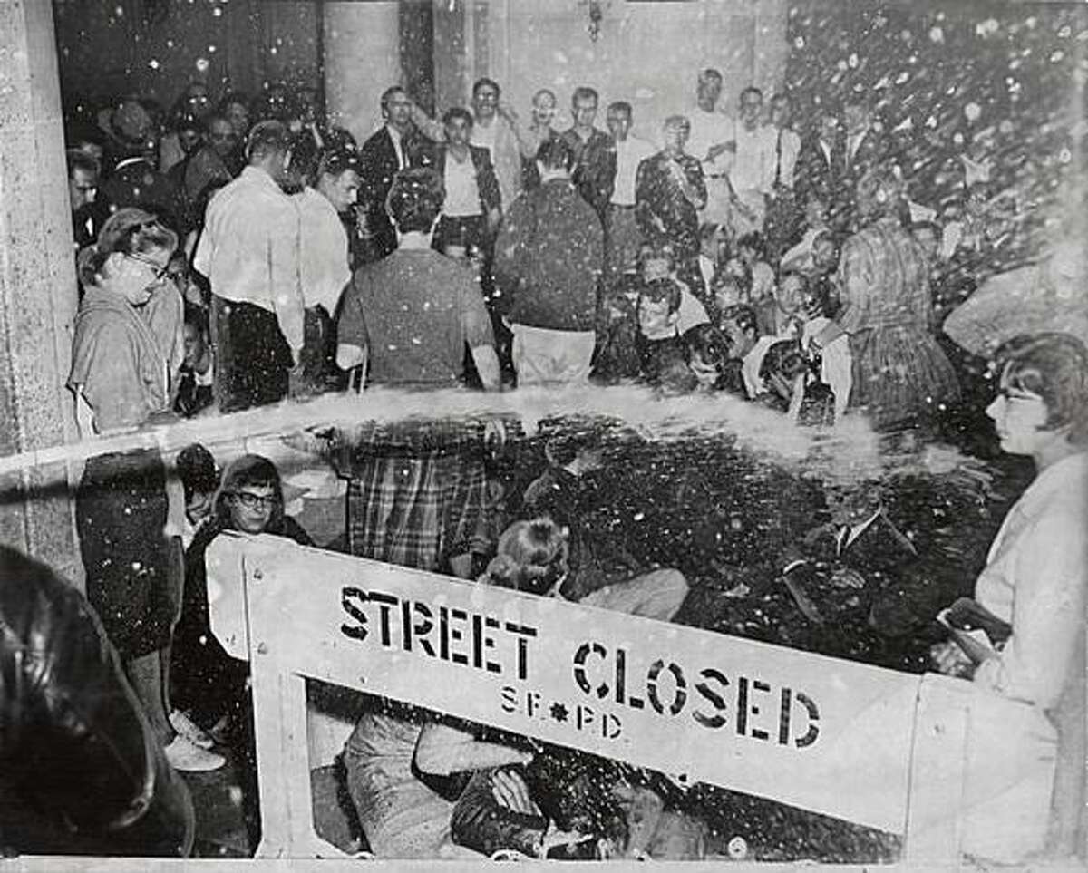 Water from a fire hose pours over a barricade onto protesters in the street during the "Black Friday" protests in San Francisco on May 13, 1960.