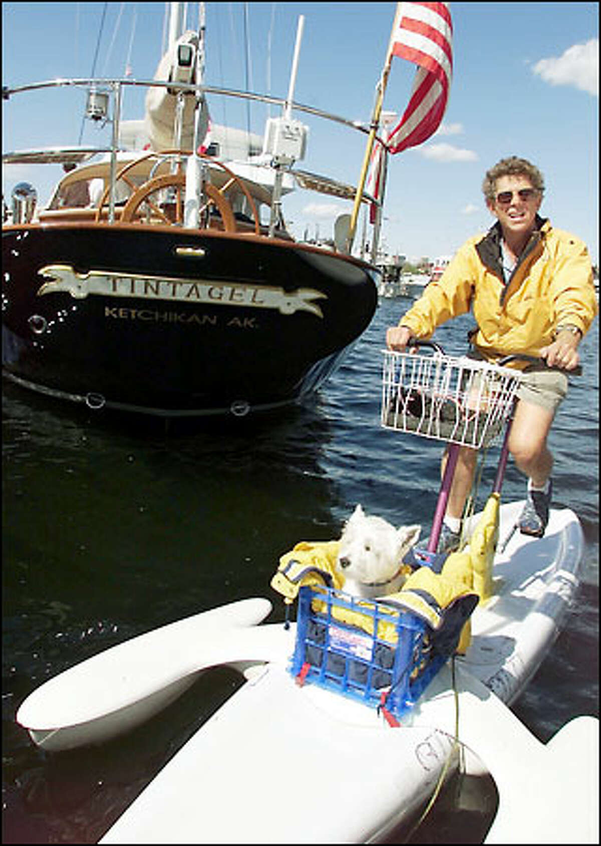 Gordon Myers and his dog Skipper use a surfbike for transport around Lake Union. Yesterday Myers toured the Fleet of Dreams & Superyacht Showcase at Chandler's Cove. The show is open to the public today from 11 a.m. to 7 p.m. and tomorrow and Sunday from 10 a.m. to 7 p.m. Many of the motor cruisers and sailboats that are on display were built in Puget Sound-area shipyards.