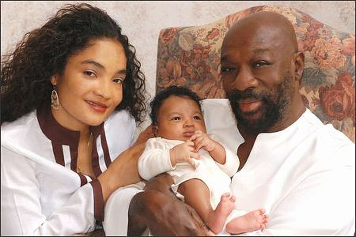 Isaac Hayes not only sings about the love thing, he brings it to its natural conclusion in real life. Pictured here are composer/crooner Hayes, wife Adjowa Hayes and their new baby boy, Nana Kwadjo Hayes, in Memphis. Daddy will rock this cradle into blissful dream time.