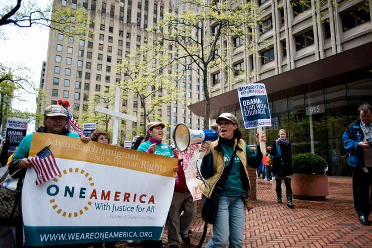 Protesters march outside of the Department of State Passport Agency on May 20, 2010 in Seattle.