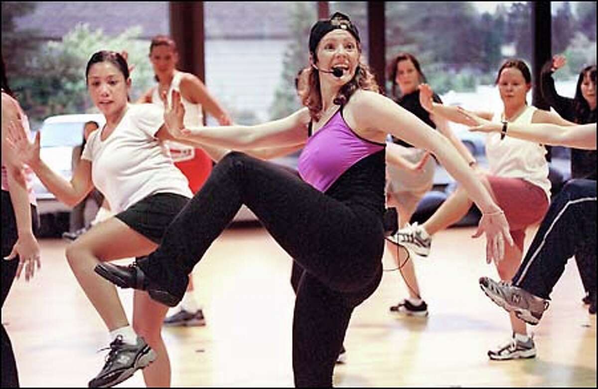 Deborah Engman, center, directs a "Get Your Body Started" hip-hop class at Bally's Total Fitness in Bellevue. "This is so unique and innovative," says Engman. "It's starting to bring dance to the gym world. It gives people more flexibility, which shocks the body."
