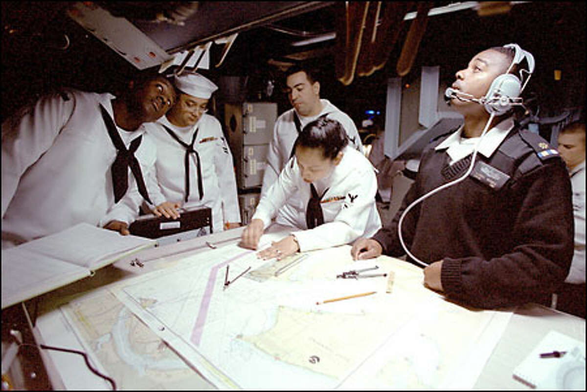 Crew members, from left, Louis Policard, Randy Neihart, David Silvia, Sandra Lebron and Darryl Rogers work in the Operation Infomation Center.
