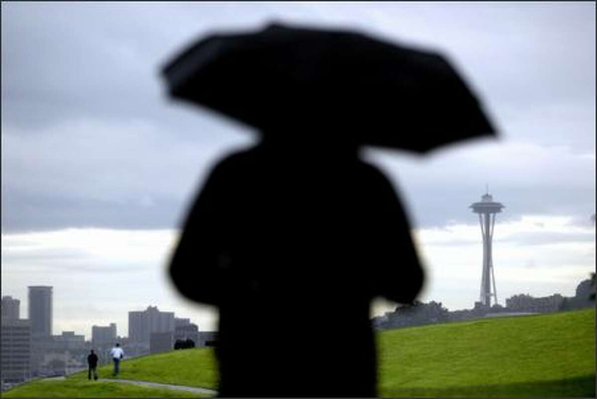 Steven Ebert of Seattle stands in the rain and takes in a very Seattle day yesterday at Gas Works Park on the north end of Lake Union. "Have a look at it, isn't it beautiful?" Ebert said, thereby perhaps placing himself in the minority. "I'm just checking out the rain and the weather. I get tired of the sun; if you want the sun, move to bloody California, that's what I say."