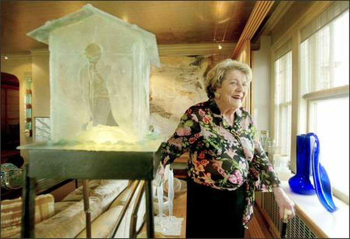 Anne Gould Hauberg, seen in her art-filled First Hill condominium, has been a major force in the arts in Seattle for 50 years. At left is a sculpture by Mary White, "Choosing To Listen to the Birds." On the window sill is a 1992 blown glass piece by Dale Chihuly, "Cobalt Ikebana."