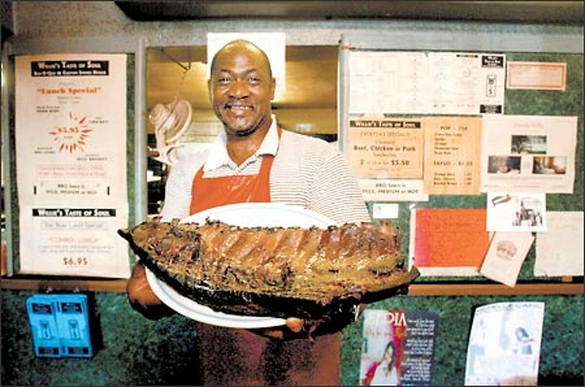 Where meat is king: Willie Turner, co-owner with his wife, Brenda, of Willie's Taste of Soul Bar-B-Que and Custom Smoke House, shows off his special rack of ribs.