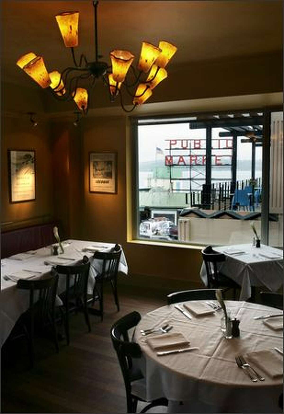 Campagne's gorgeous butterscotch-hued dining room overlooks Pike Place Market and Elliott Bay.