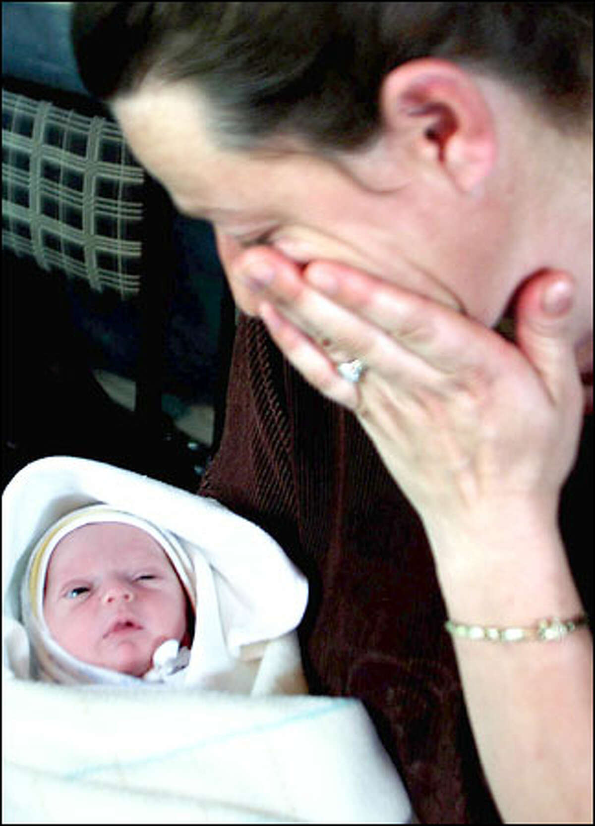 Ethnic Albanian Lirije Arifi weeps as she looks at her 3-day-old daughter, Leutrim, one of the youngest refugees who crossed into Kosovo. The U.N. agency there reported about 42,000 refugees from Macedonia.