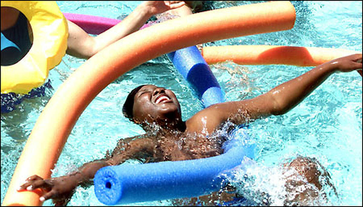 Deonte White, 10, from Graham Hill Elementary School, enjoys a field day at Colman Pool in West Seattle's Lincoln Park. A day before the first day of summer, temperatures soared to 79 degrees.