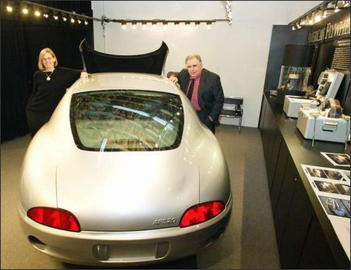 Laurie Westdahl and Ed Furia with the concept car that would hold the flywheel-hybrid engine their company is developing. Westdahl designed the car, and Furia is CEO of AFS Trinity Power Corp. The company is seeking an automaker to collaborate with -- and $120 million in financing.