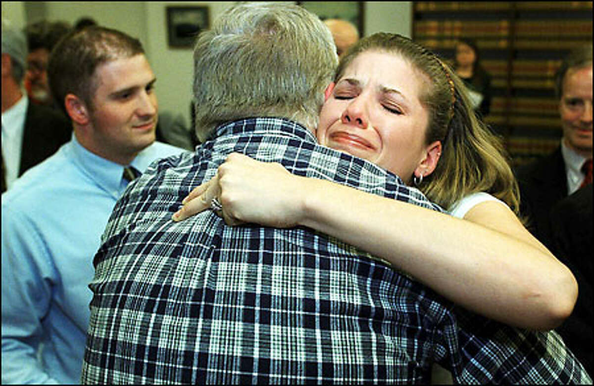 Jennifer Rufer hugs jury foreman Rolf Johannessen after winning her lawsuit against Abbott Laboratories and the University of Washington.