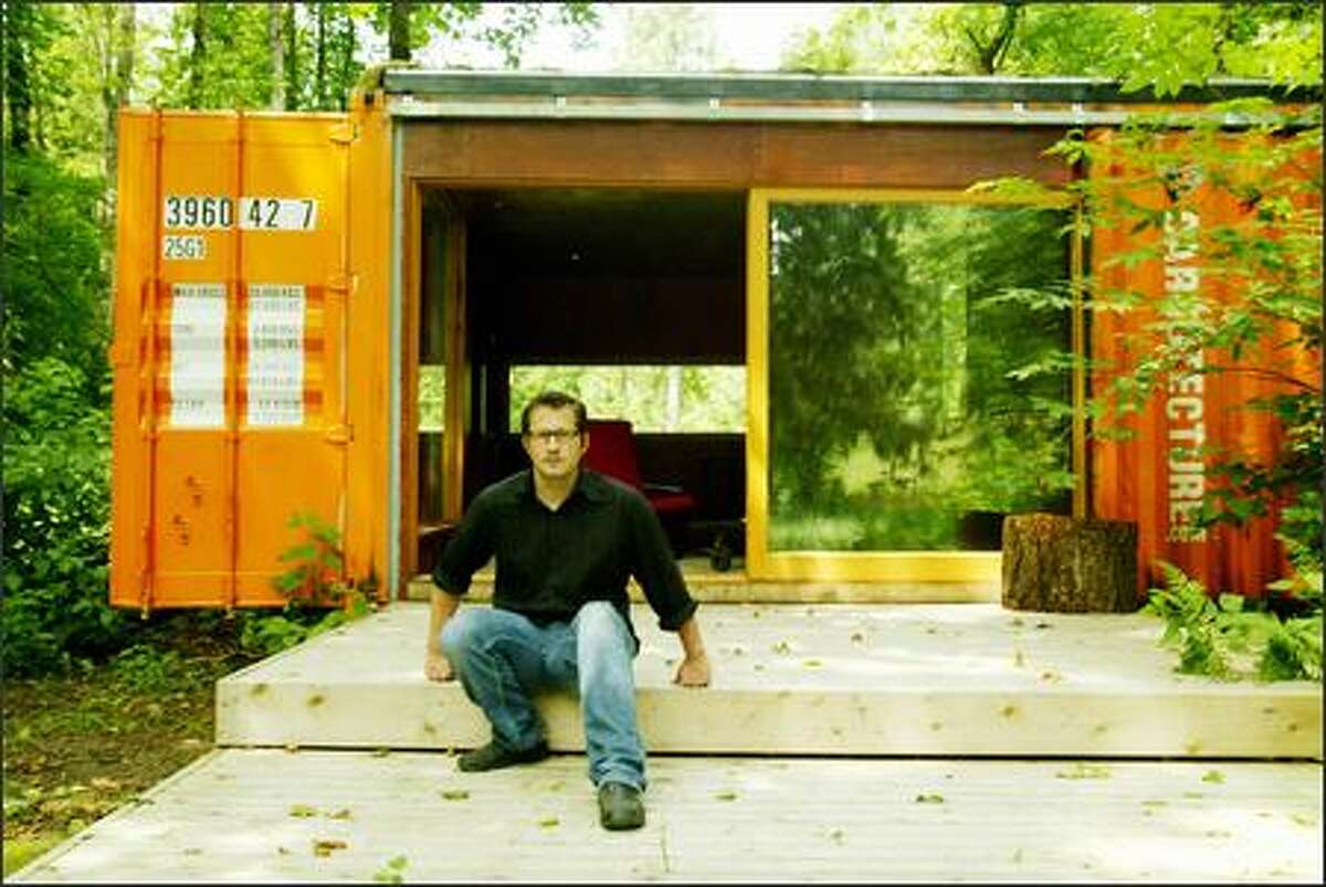 (Editor's Note: This caption has been altered. Joel Egan, one of the partners in Studio 320, which advocates using cargo containers for housing, is a designer. His profession was misstated in the original version of this caption.) Designer Joel Egan, above, and architect Robert Humble designed this cabin in Enumclaw using shipping containers. Cargo containers are cheap, plentiful, strong and durable.