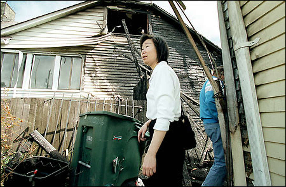 Su Jin has lived in this house at 3022 18th Ave. S. on Beacon Hill for 11 years. A fire Wednesday night caused about $200,000 in damage and badly damaged the house next door, too. Jin was unhurt.