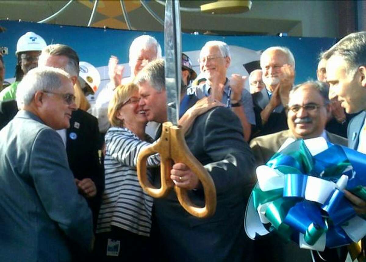 Sound Transit Executive Director Joni Earl, right, and Seattle Mayor Greg nickels hug after cutting the ribbon for the light-rail line.