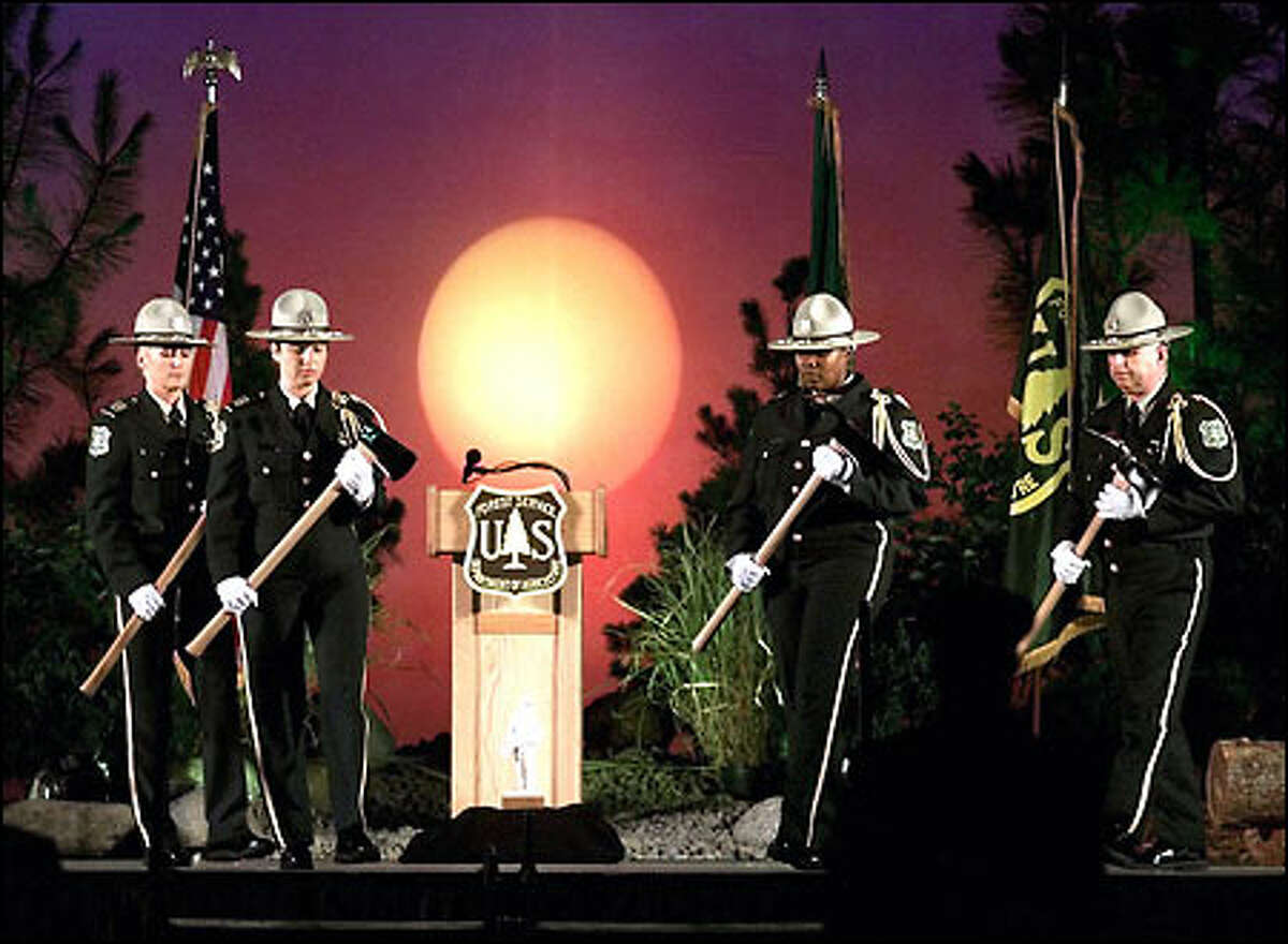 Members of the Forest Service rifle drill team honor Devin Weaver, Jessica Johnson, Karen Fitzpatrick and Tom Craven at the Thirty Mile Fire Memorial service.