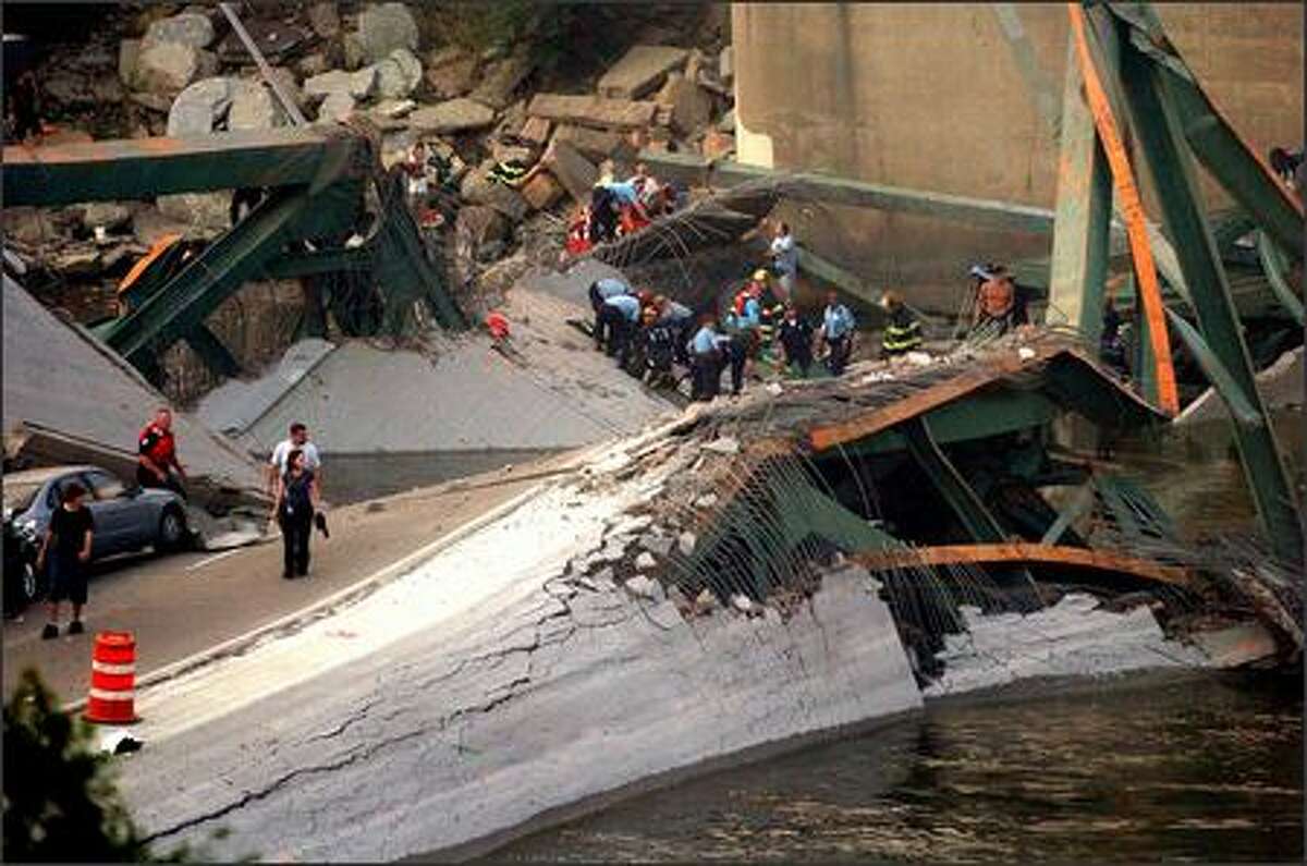 Emergency personnel work at the scene of a bridge collapse in Minneapolis on Wednesday.