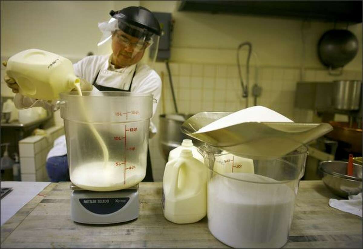 Ha Tran measures cream from Fresh Breeze at Fran’s Chocolates. Vat pasteurizing at the Lynden dairy produces more flavorful milk and cream.