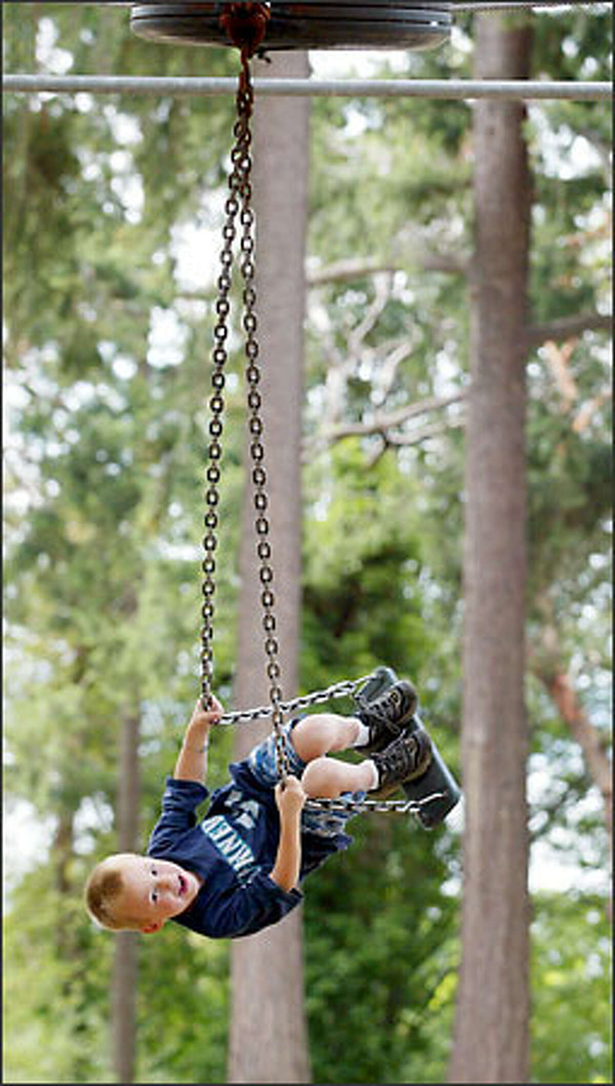 Give 5-year-old Morgan Higgins of West Seattle extra style points for his flashy little maneuver on the 50-foot-long cable glide at West Seattle's Lincoln Park. It may not look like it in this photo, but the cable glide is a safe, low-height ride.
