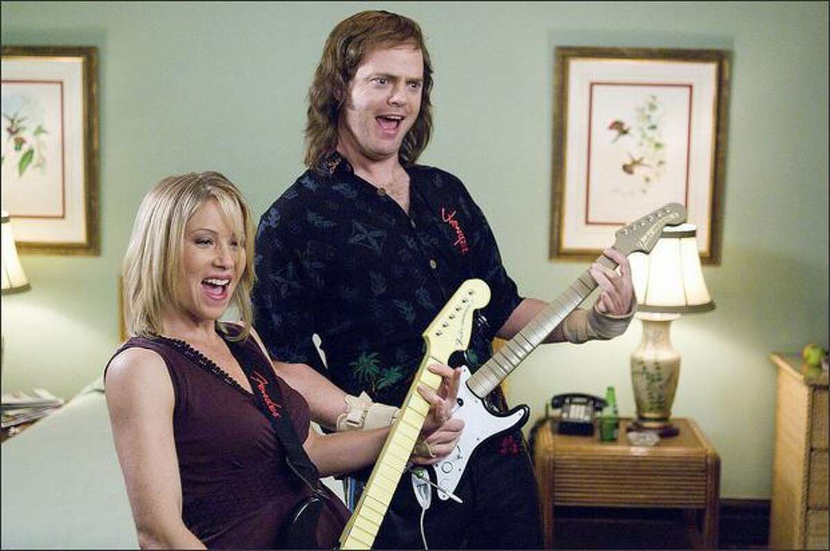 Robert "Fish" Fishman (Rainn Wilson) and Kim (Christina Applegate) enjoy playing a music video game in "The Rocker."