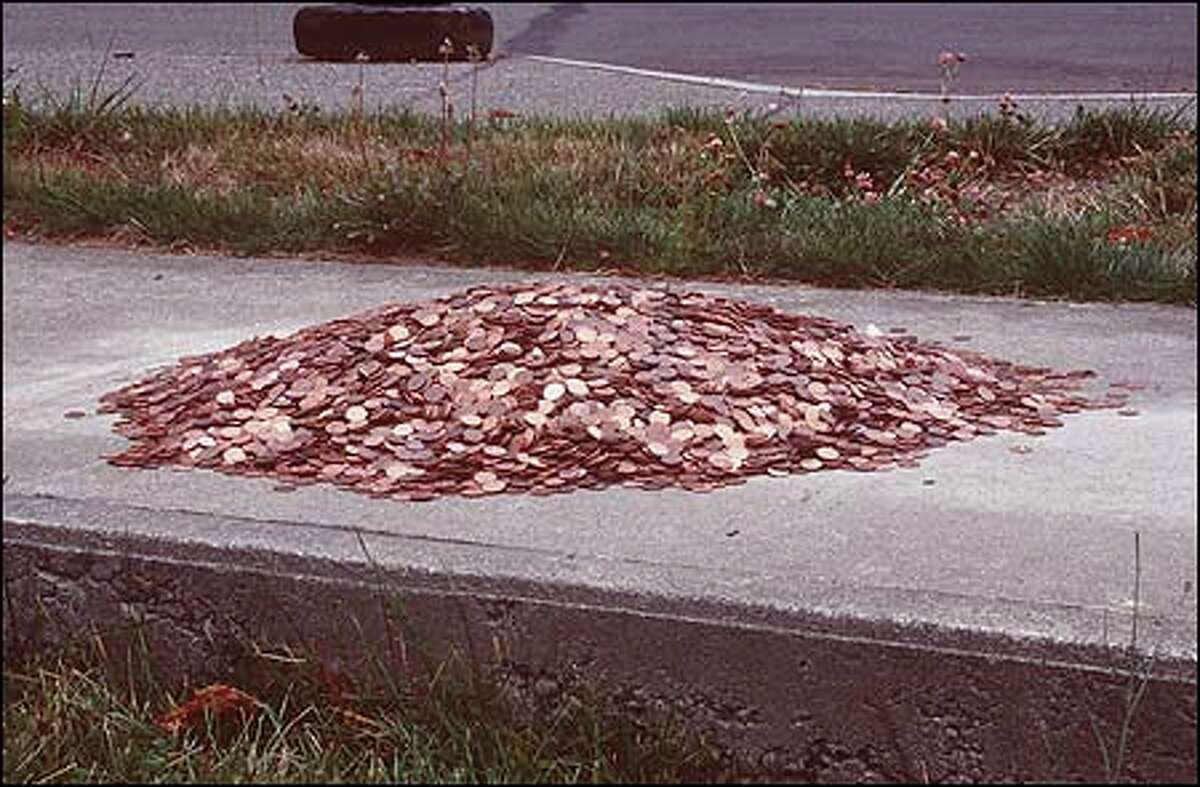 Brad Miller's heap of 50,000 pennies on a sidewalk toys with the idea that, in a capitalist society, art equals money.