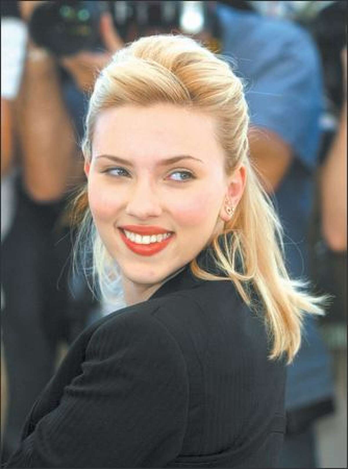 Scarlett Johansson is fine in body, if not spirit, after a collision Thursday in a Disneyland parking lot. She and two friends were being tailed by paparazzi when Johansson swerved, clipping a car carrying a woman and two kids. Her rep said the frustrated star hopes lawmakers crack down on aggressive photo hounds.