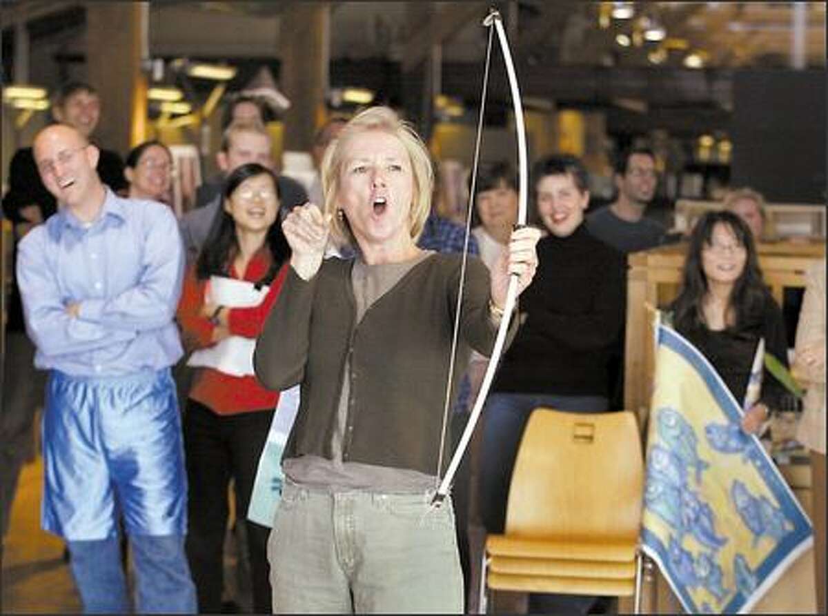 Lisa Folkins, a site planner and principal at Seattle architecture firm Mithun, reacts to her shot with a toy bow at the company's second Mithun Olympics, held in honor of the international sporting event. Company employees took a break during the workday to participate in an archery competition.