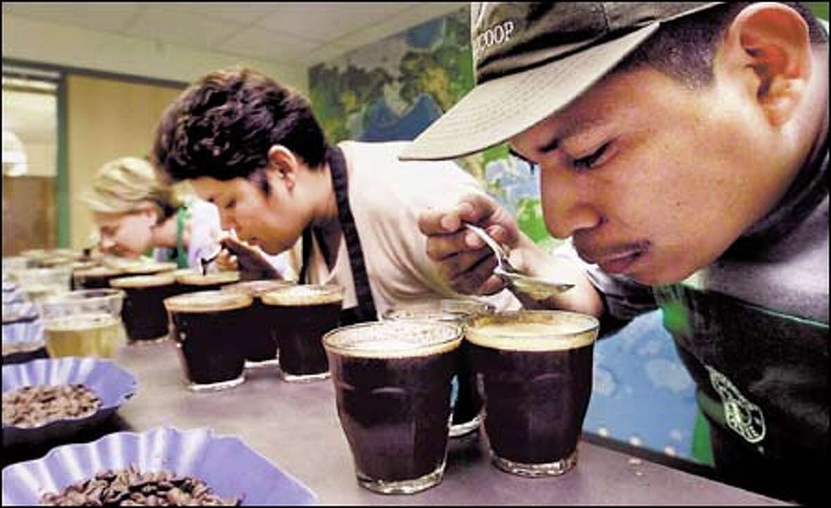 Farmer Clemente Carazo tastes coffee at the Starbucks headquarters with Mary Williams, far left, a Starbucks vice president, and Merling Preza, general manager of Prodecoop.
