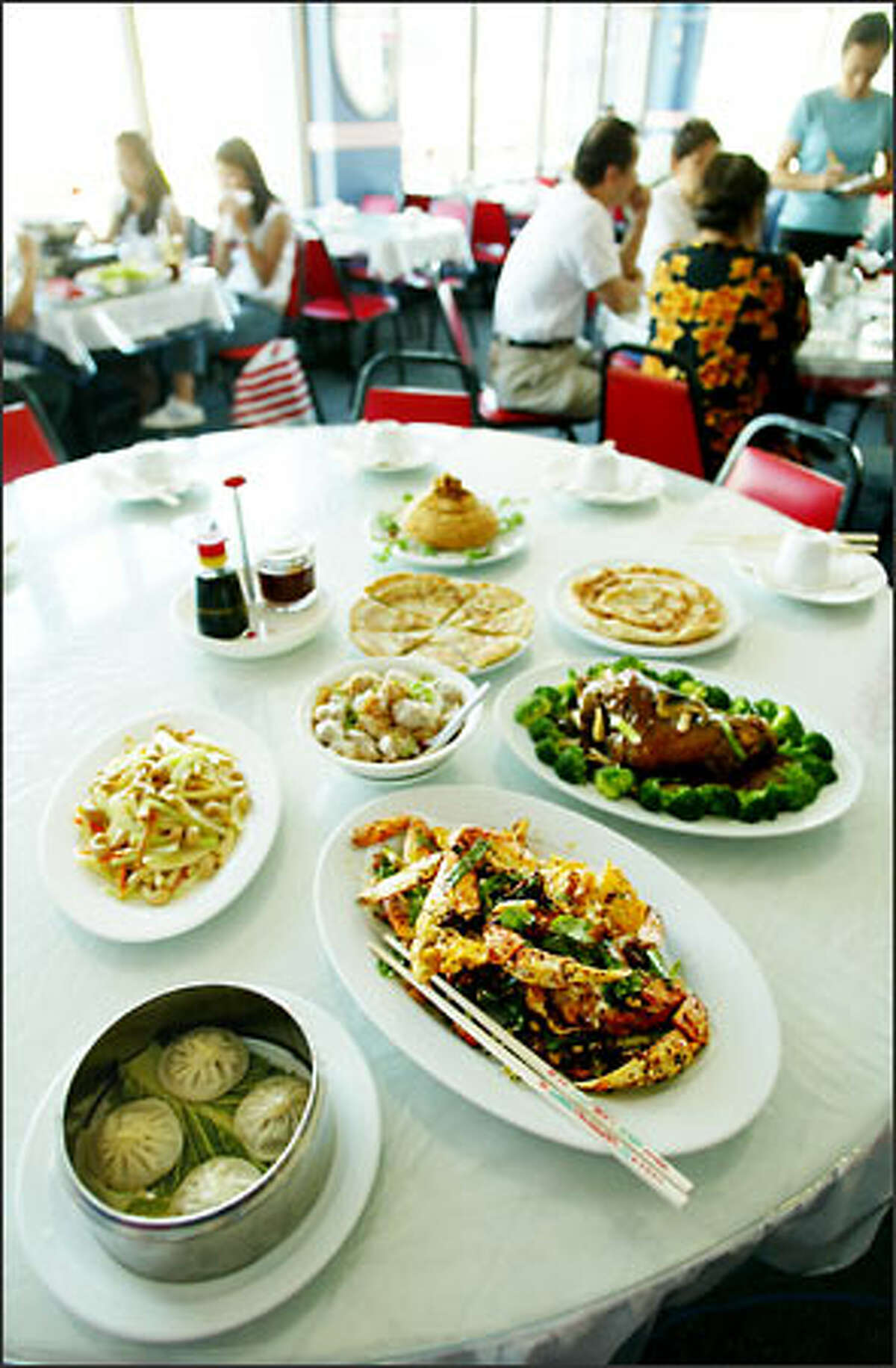 Some of the specialties of Seven Stars Pepper Szechuan Restaurant include, at left foreground, steamed pork buns and Szechuan crab.