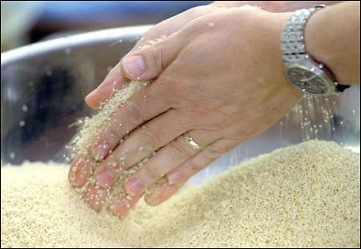 After adding water and letting stand for about 20 minutes, Mustapha Haddouch then rubs the couscous together to fluff the grains and break up lumps before cooking.