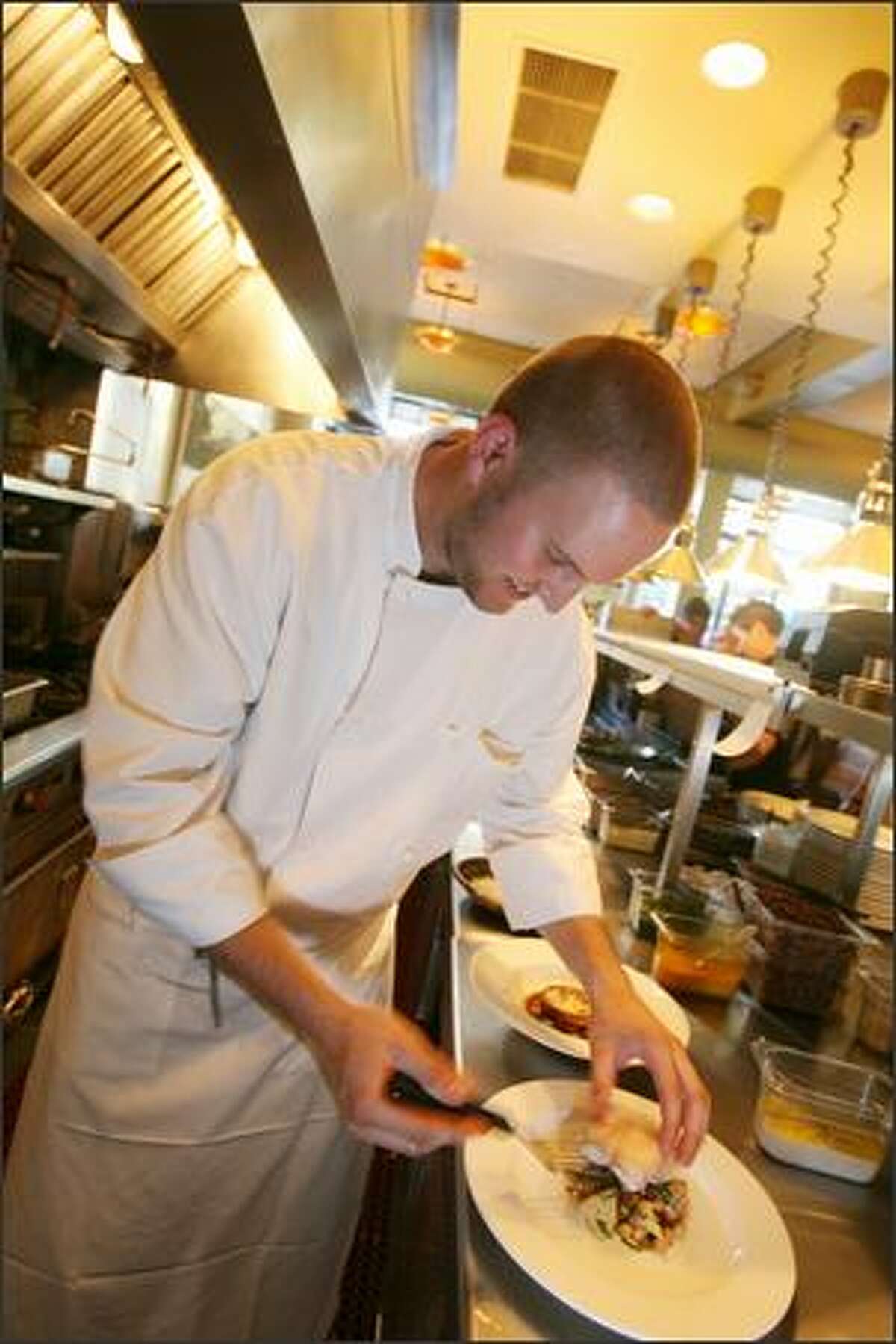 Chef de cuisine Daniel Newell plates rockfish. The experienced staff delivers a night that's full of polish and pleasure.