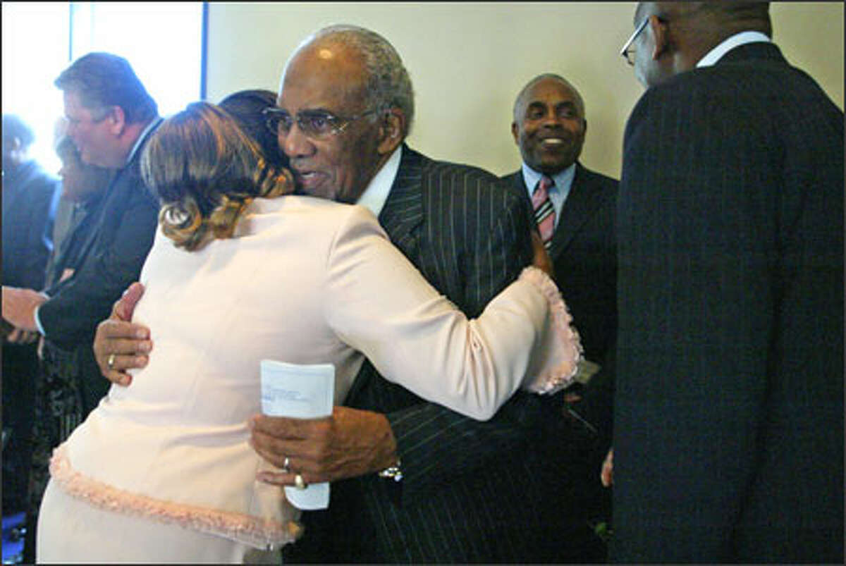 Josephine Howell hugs the Rev. Samuel B. McKinney after the second service Sunday at Mount Zion Baptist Church. His return is widely celebrated.