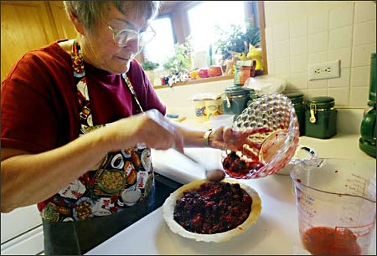 Carol Lagasca practices making the Merry Marionberry Pie she'll enter in the Puyallup Fair, where she's won first place in every pie category. At the top are her many ribbons.