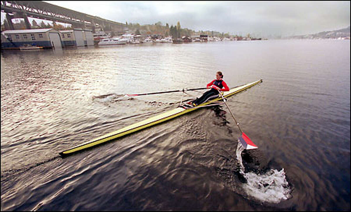 Laura Rauchfuss sculls on Lake Union during a morning practice. Rauchfuss moved here last year from Georgia to train with the elite squad at the Pocock Rowing Center. In June, she won a bronze medal in double sculling at the Rowing World Cup held in Spain.