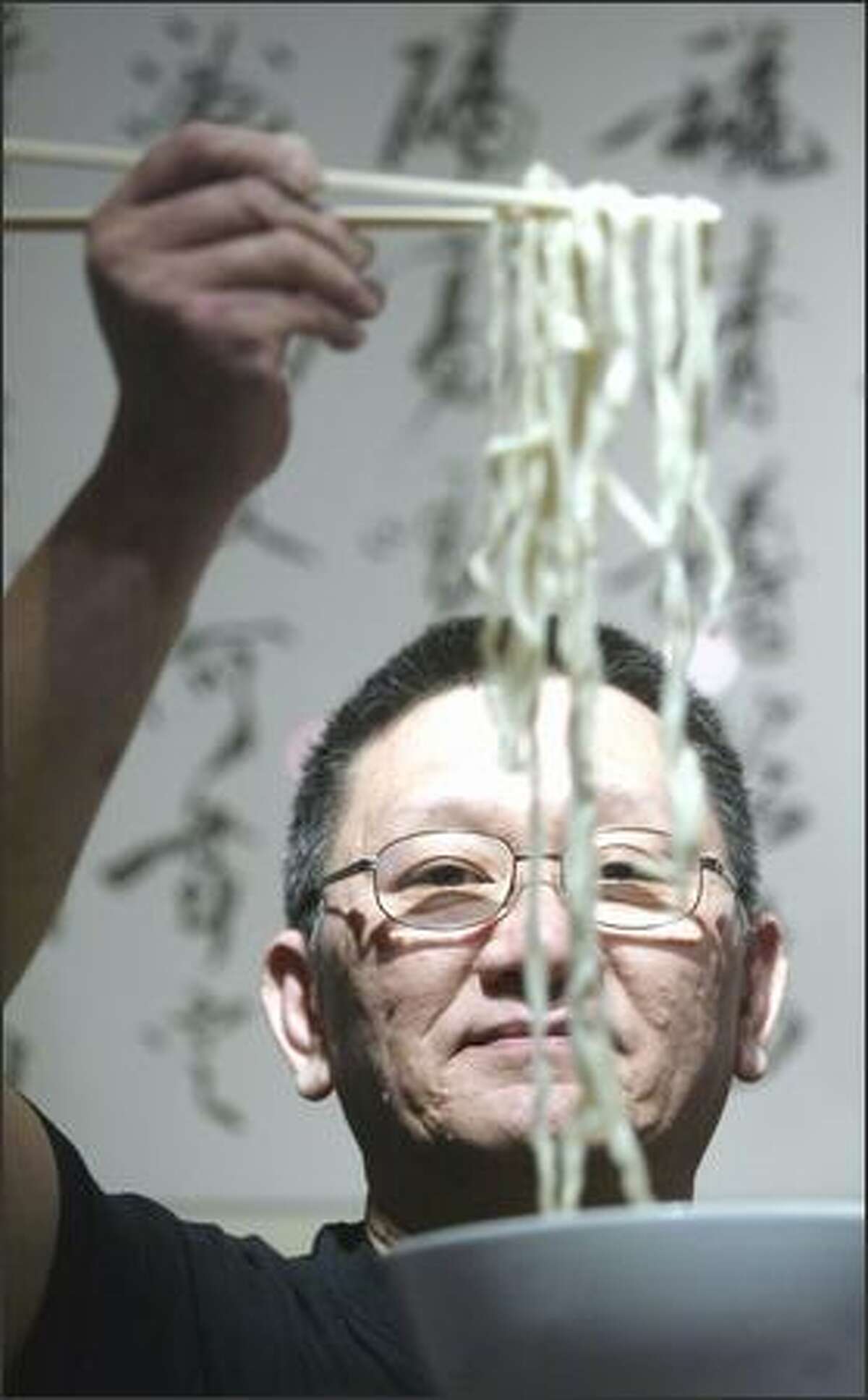 William Chiang, owner of Chiang's Gourmet, shows off his fresh handmade noodles, a Shanghai-style specialty.