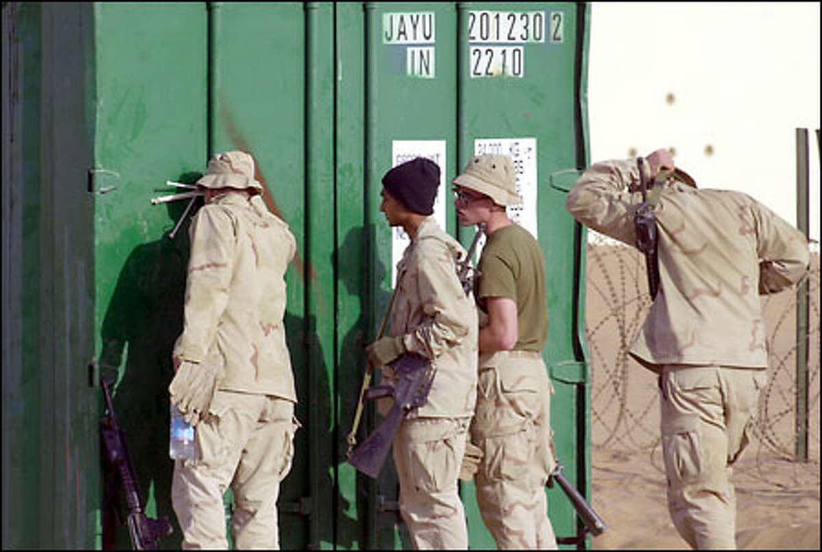 Marines speak to someone in a container, but who? Officials say the only detainee at the desert base is American John Walker, a Taliban fighter.