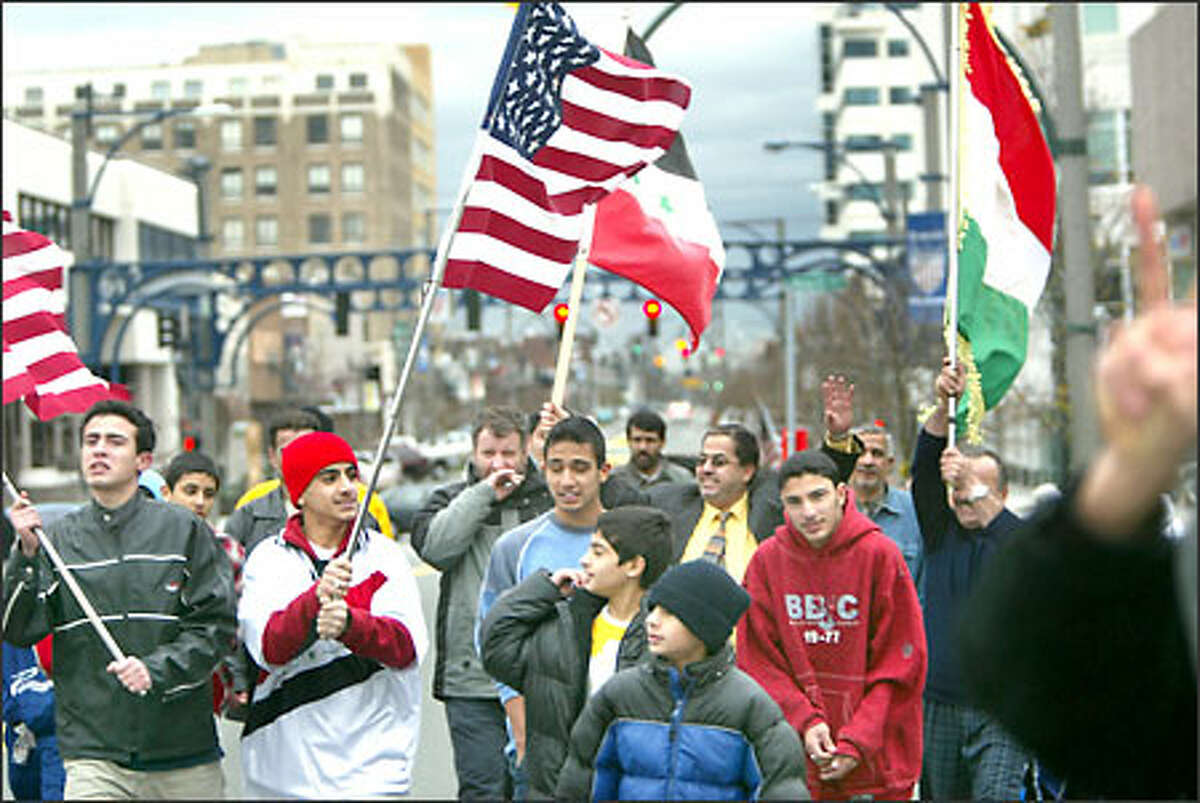 Members of the Iraqi American community celebrate in downtown Everett. The celebration began early yesterday morning.