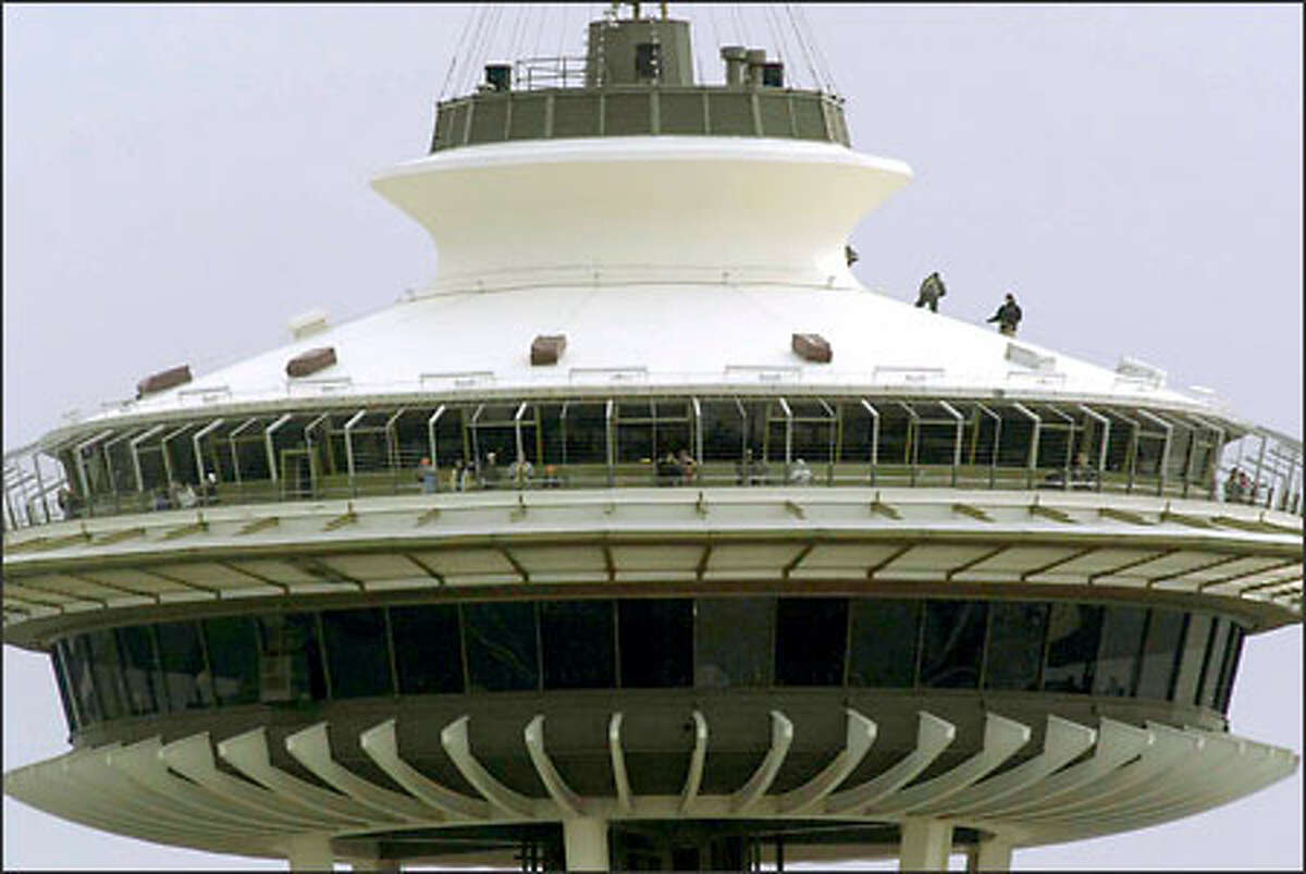 Workers install fireworks on top of the Space Needle for New Year's Eve.