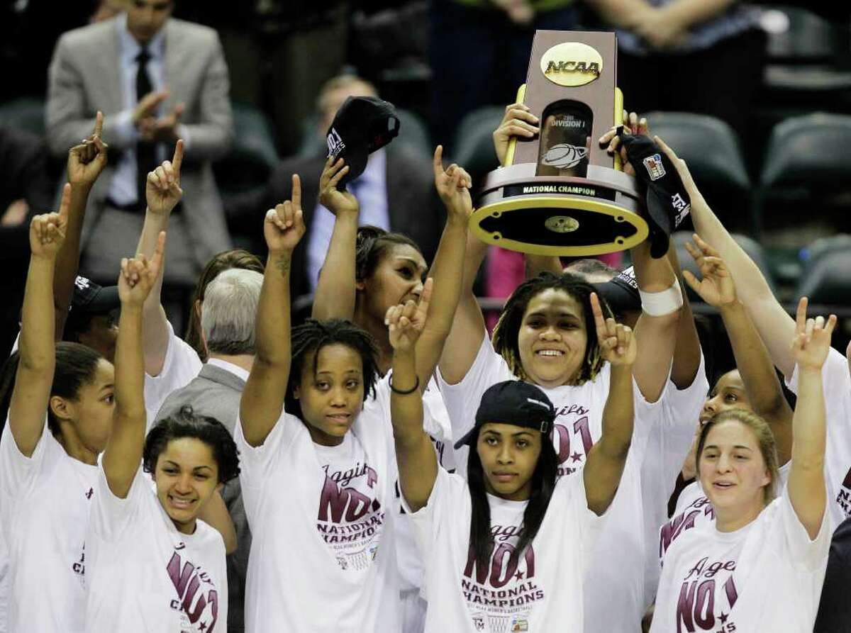 Texas A&M players celebrate with the trophy after their 76-70 win over Notre Dame in the women's NCAA Final Four college basketball championship game in Indianapolis, Tuesday, April 5, 2011.