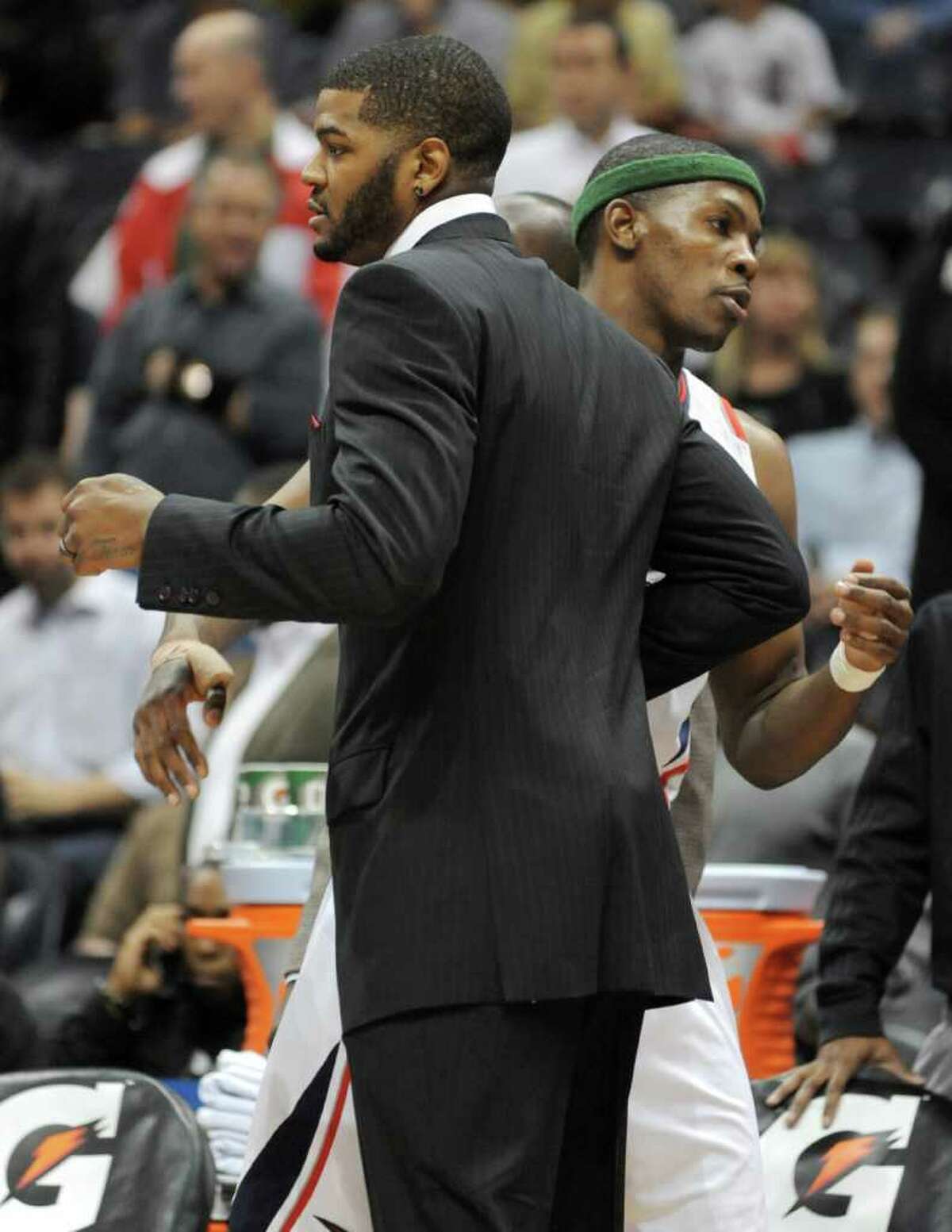 Atlanta Hawks forward Josh Smith, left, greets teammate Joe Johnson before the Hawks hosted the San Antonio Spurs in an NBA basketball game Tuesday, April 5, 2011, at in Atlanta. Smith has sweliing in his right knee and was unable to play.