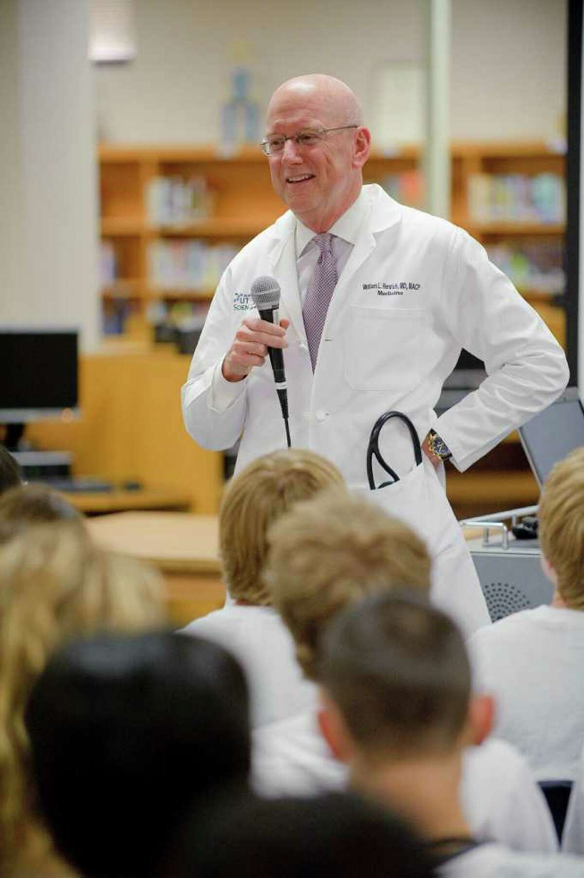 Dr. William Henrich, president of the UT Health Science Center San Antonio, addresses the ninth- to 12th-grade science classes at Health Careers High School in the Northside Independent School District. Henrich is a nephrologist, a specialist in the function and diseases of the kidney.