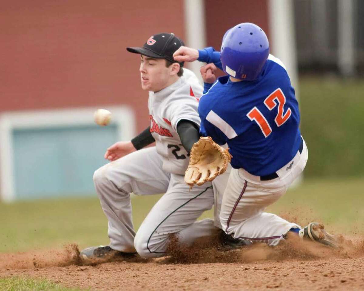 Danbury's J.P. Dennehy steals second base as New Canaan's Doug Reilly reaches for the late throw Wednesday at Danbury High School.