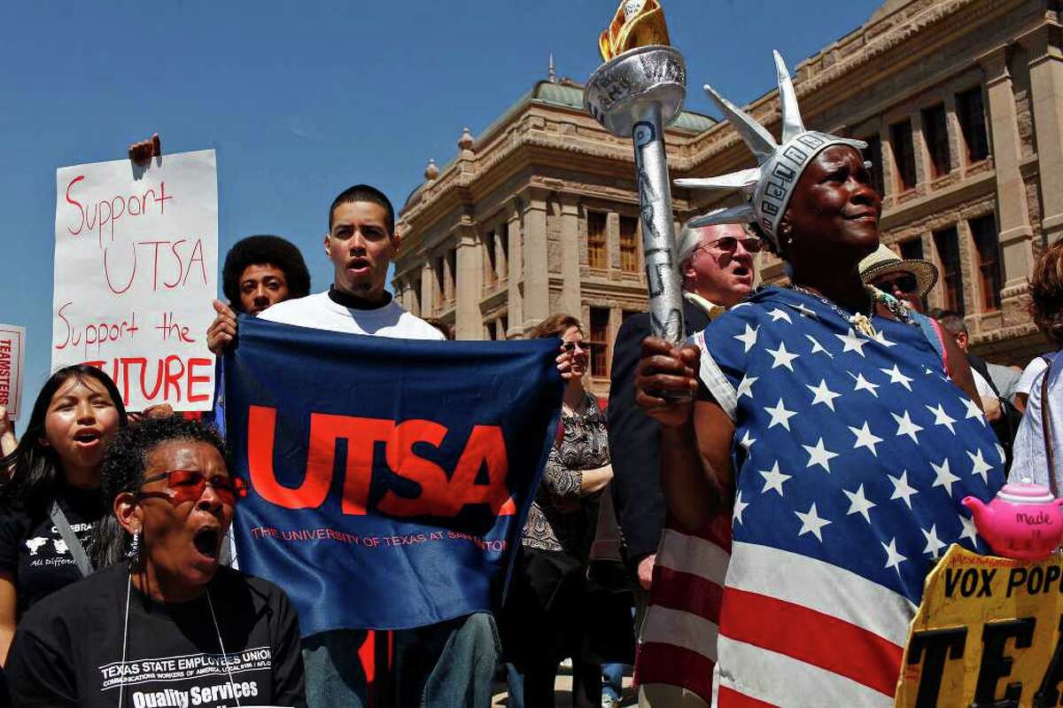 UTSA students including Xavier Johnson (left) and Rene Amaya (center), cheer with Peace Washington Costanzo, (right), of Dale, during the Save our State rally at the State Capital in Austin on April 6.