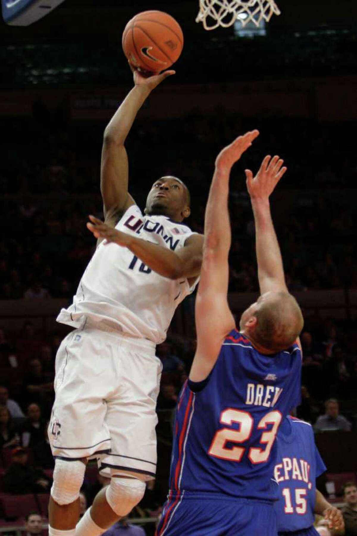 Butler center Andrew Smith (44) puts up a go-ahead score against Pittsburgh  guard Ashton Gibbs (12) with only seconds remaining in a third-round game  of the 2011 NCAA Men's Basketball Championship tournament