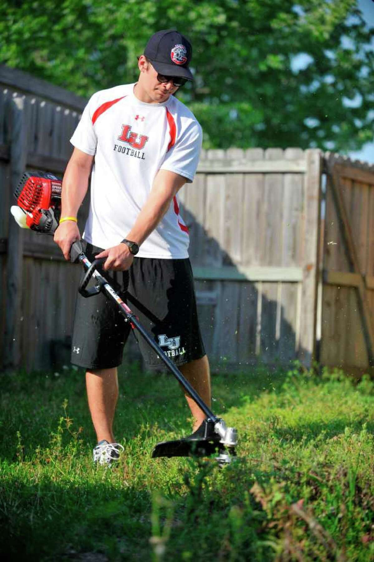 Mow money Lamar football player Harrison Tatum cuts grass for extra cash