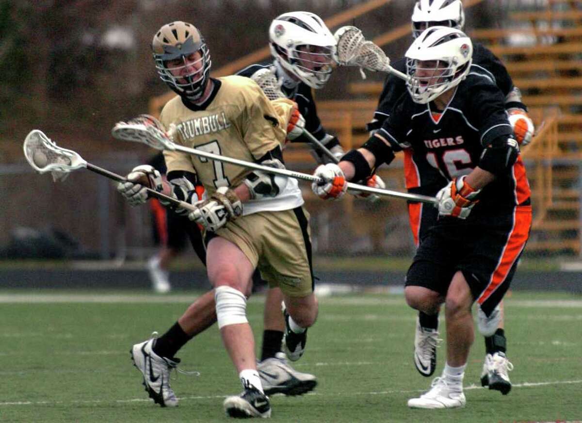 Ridgefield's #16 Jordan Nachowitz, right, looks to stop an advance by Trumbull's #7 Ken Kaczmarczyk, during boys lacrosse action in Trumbull, Conn. on Friday April 8, 2011.